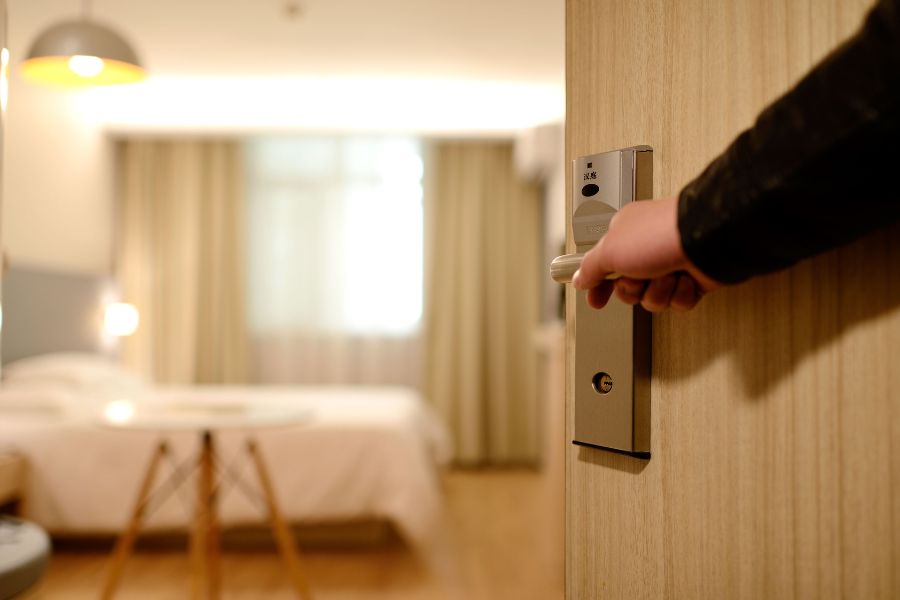 Opening the door to a hotel room.